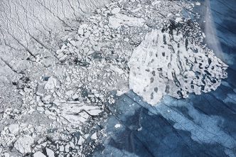 Daniel Beltrá, Water collects in unnamed seasonal lake atop the Greenland ice sheet, 75 miles southeast of Ilulissat. With the Earth’s warming climate, the melt season now stretches 70 days longer than it did in the early 1970s, 2014. From the series Greenland, Courtesy of the artist and Catherine Edelman Gallery-Chicago