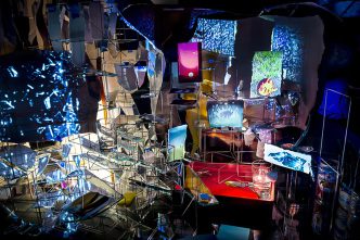 Sarah Sze, Timekeeper (2016), Mixed media, mirrors, wood, stainless steel, archival pigment prints, projectors, lamps, desks, stools, stone, Dimensions: variable, Courtesy of the artist Victoria Miro Gallery and Copenhagen Contemporary