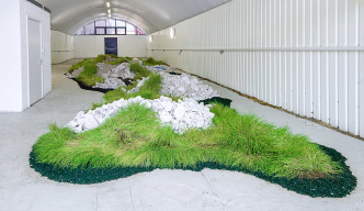 Rachael Champion, New Spring Gardens, 2016, Building site rubble (BT telephone exchange, Vauxhall), wheat grass, rubber bark chipping, pool cover weights (water bags), 150 × 900 × 2800 cm, Commissioned by Nine Elms on the South Bank, Installation view: Arch 147, Newport Street, Nine Elms on the South Bank, Vauxhall, 2016, Photo: Jess Littlewood