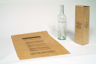 Marcel Broodthaers, Le manuscrit trouvé dans une bouteille, 1974, transparent Bordeaux wine bottle, wrapped in white tissue paper (Manuscript), in a small cardboard packing, S.M.A.K. Collection since 1979