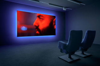 Installation view TOWERMMK, Azin Feizabadi, Cryptomnesia, 2014, 73 min., video, color, sound, Script, directing, editing: Azin Feizabadi; cast: Rusbeh Sarfaraz (as Reinoldus), Dorothee Neff, Illias Nikolaidis, Maik Banach aka DJ Emby, Alvin Ejiro Aggreh, Tommy Catalano, Abdelaziz Lahmar, Daniel Wechsler, Sotiris Makris; Production management: Daniel Pauls; Director of photography: Karsten Jäger; Additional camera: Rusbeh Sarfaraz and Azin Feizabadi; Title design: Maziyar Pahlevan; Music: “Modern Persian Speech Sounds”, Omid Walizadeh (B|ta’arof Records); “Homayoon” composition and setar: Amen Feizabadi, © Azin Feizabadi, Photo: Axel Schneider