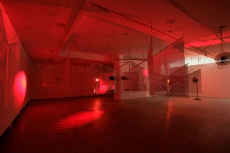 Haegue Yang, Yearning Melancholy Red, 2008. Aluminum venetian blinds, powder-coated aluminum hanging structure, steel wire rope, mirror, moving spotlights, infrared heater, timer, fan, drum kit, trigger, MIDI converter, cable, 362 x 1450 x 1571 cm. Courtesy of Galerie Barbara Wien, Berlin. Installation view of Asymmetric Equality, REDCAT, Los Angeles, USA, 2008 Photos: Scott Groller