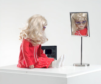 Lynn Hershman Leeson, CyberRoberta, 1996. Custom-made doll, clothing, glasses, webcam, surveillance camera, mirror, original programming, and telerobotic head-rotating system, Aprox. 17 ¾ x 17 ¾ x 7 ⅞ in / 45 × 45 × 20 cm, Courtesy the artist; Anglim Gilbert Gallery-San Francisco; and Bridget Donahue Gallery-New York