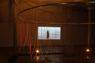 Zhanna Gladko, Vicious Circle, 2021, Installation with piano bass strings, video projections; 400 x 400 cm, © Zhanna Gladko, Courtesy the artist