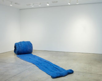 Cecilia Vicuña, Caracol Azul (Blue Snail), 2017, Unspun wool, site-specific installation, 30.25 x 201.75 x 40.5 inches (installed) 76.8 x 512.4 x 102.9 cm, overall dimensions variable, © Cecilia Vicuña, Courtesy the artist and Lehmann Maupin Gallery